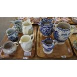 Two trays of 19th Century creamware and pearlware and other jugs, some transfer printed, some