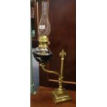 Early 20th Century double oil burner lamp with clear glass chimney and reservoir on a swivel stand