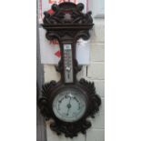 Early 20th Century heavily carved foliate oak framed aneroid wall barometer. (B.P. 21% + VAT)