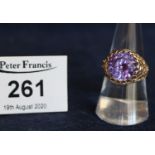 A 9ct gold synthetic alexandrite dress ring. Ring size O & 1/2, 5.8g approx. (B.P. 21% + VAT)
