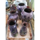 Six Torquay pottery Lemon and Crute vases of varying designs including a pair of baluster vases