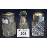 Three cut glass scent bottles, including; two straight sided examples with silver covers and a small