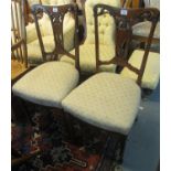 A pair of Edwardian mahogany inlaid dining chairs with stuff over seats standing on square