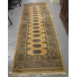 Middle Eastern design runner on a beige ground with geometric and stylised floral decoration. 245