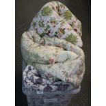 Box containing three vintage quilted bedspreads, one floral the other two decorated with plants,