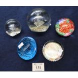 A group of five glass paperweights; one shaped as a limpet, one from the National Gallery and a
