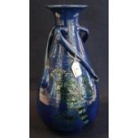 C.H Brannam Pottery three handled baluster vase with flared neck decorated with a stylised parrot on