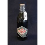 A 75th Anniversary 1907-1982 unopened bottle of Coca-Cola. 10 fluid ozs with vintage labelling and