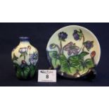 Modern Moorcroft art pottery tube lined bud vase, overall decorated with purple flowers and foliage,