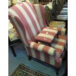 Early 20th Century wing back upholstered armchair on cabriole legs, together with a similar foot