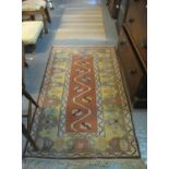 Turkish Melas rug on a salmon ground with stylised petals and meandering border design, together