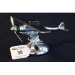 Novelty chrome plated American table lighter in the form of a vintage monoplane aircraft on circular