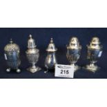 Collection of silver condiments to include; pair of urn shaped pepperettes, another repousse