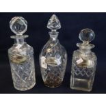 Three cut glass decanters and stoppers with silver decanter labels, 'Gin', 'Whisky' and 'Sherry.