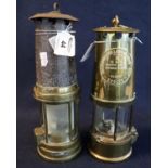 Two brass miner's safety lamps, one unnamed and appearing well used, the other by Protector Lamp and