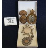 Two military cap badges and a silver fob and another white metal fob. (4) (B.P. 21% + VAT)