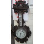 Early 20th Century heavily carved foliate oak framed aneroid wheel barometer. (B.P. 21% + VAT)