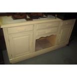 Painted pine dog kennel dresser base with an arrangement of four drawers over two panelled cupboards