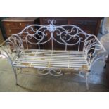 Wrought iron scroll decorated weathered garden bench. (B.P. 21% + VAT)
