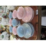 A tray of unmarked blue and pink cups and saucers decorated with moulded petals. (B.P. 21% + VAT)