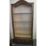 French walnut and mixed woods dome top display cabinet with glass shelves standing on carved foliate