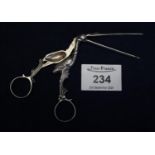 Pair of white metal sugar tongs or candle snuffers in the form of a stork with long beak, loop