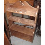 Stained pine waterfall type four shelf hanging bookcase with broken arched back. 52cm wide