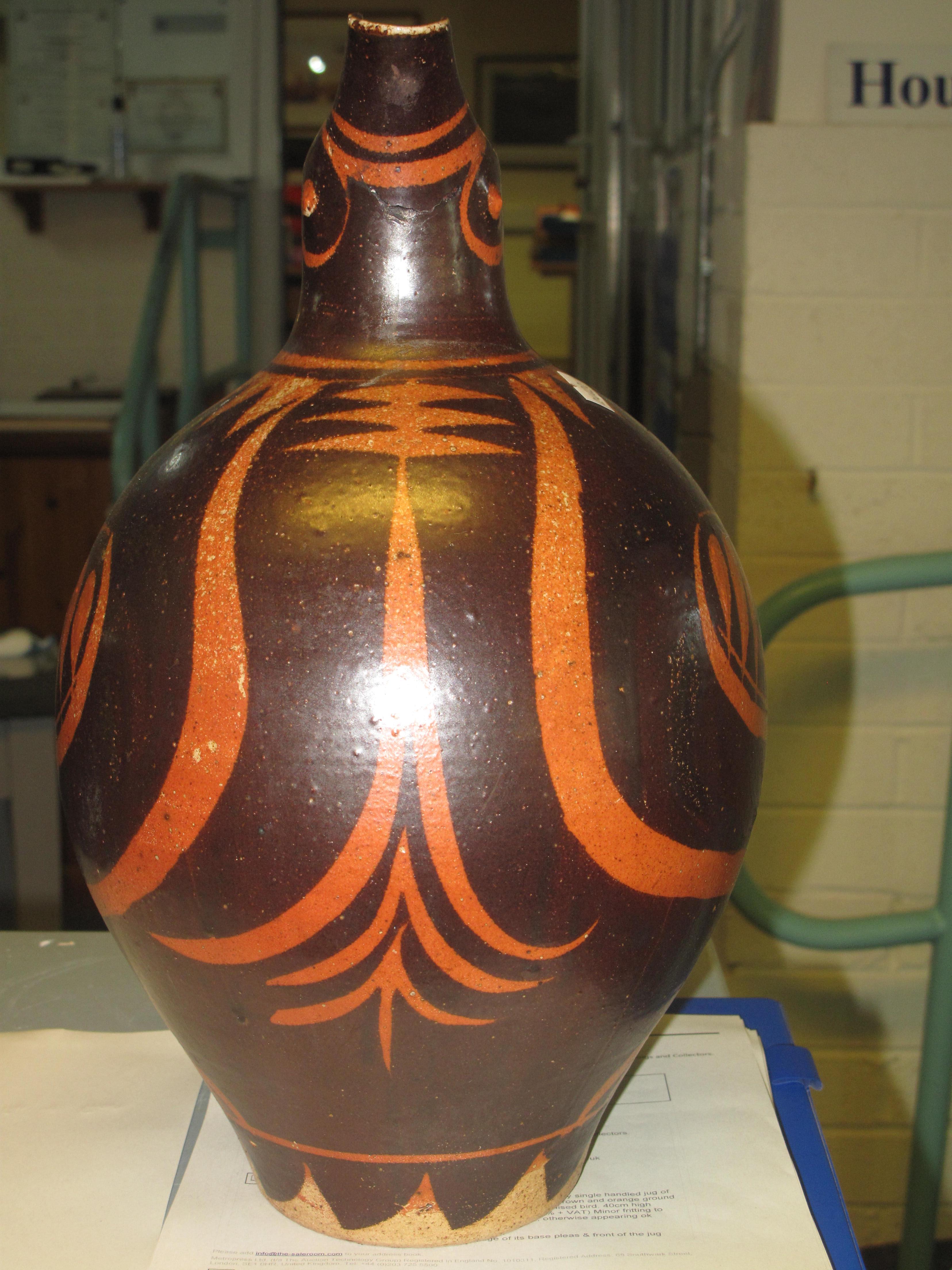 An unusual Art pottery single handled jug of baluster form on a brown and orange ground in the - Image 4 of 4