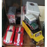 Two trays of assorted modern novelty biscuit or sweet tins in the form of cars, a radio, truck,