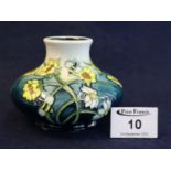 A Moorcroft art pottery tube lined vase of squat form decorated with bees, flowers and foliage,