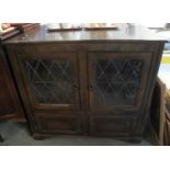 Mid Century oak Old Charm style astragal leaded glazed display cabinet on bracket feet. (B.P.