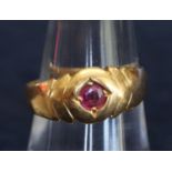 22ct gold ring set with a red stone. Ring size P. Approximate weight 5.7g. (B.P. 21% + VAT)
