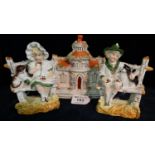 Staffordshire pottery study of a cottage together with a pair of German figurines seated on a