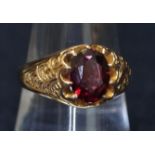 9ct gold garnet ring with engraved band. Approximate weight 4.5g. (B.P. 21% + VAT)