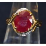 18ct gold ring set with a treated ruby and diamonds. Ring size N. Approximate weight 5.3g. (B.P. 21%