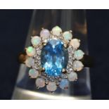 9ct gold blue topaz and opal ring. Approximate weight 4g. (B.P. 21% + VAT)
