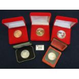 Collection of cased coins to include; Zambia 5 shillings, Canada 1972 dollar and three Millennium