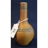 A probably Chinese porcelain small baluster vase encased in a decorative bamboo weave cover. (B.P.