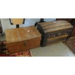 Vintage domed top trunk with wooden and metal banding and leather carrying handles, together with