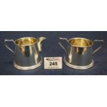 Matching silver conical shaped cream jug and matching two handled sucrier, Birmingham hallmarks. 3.6