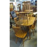 Ercol style dining table of oval form, together with a set of six Ercol style beech spindle back