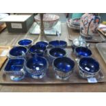 A collection of silver plated bowls with blue glass liners, a plated apple bowl, bon-bon dish