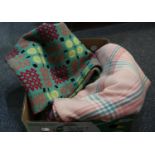 Three vintage woollen blankets; one a green ground Welsh tapestry and the other two check