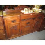 Art Nouveau design oak carved sideboard standing on turned supports. (B.P. 21% + VAT)