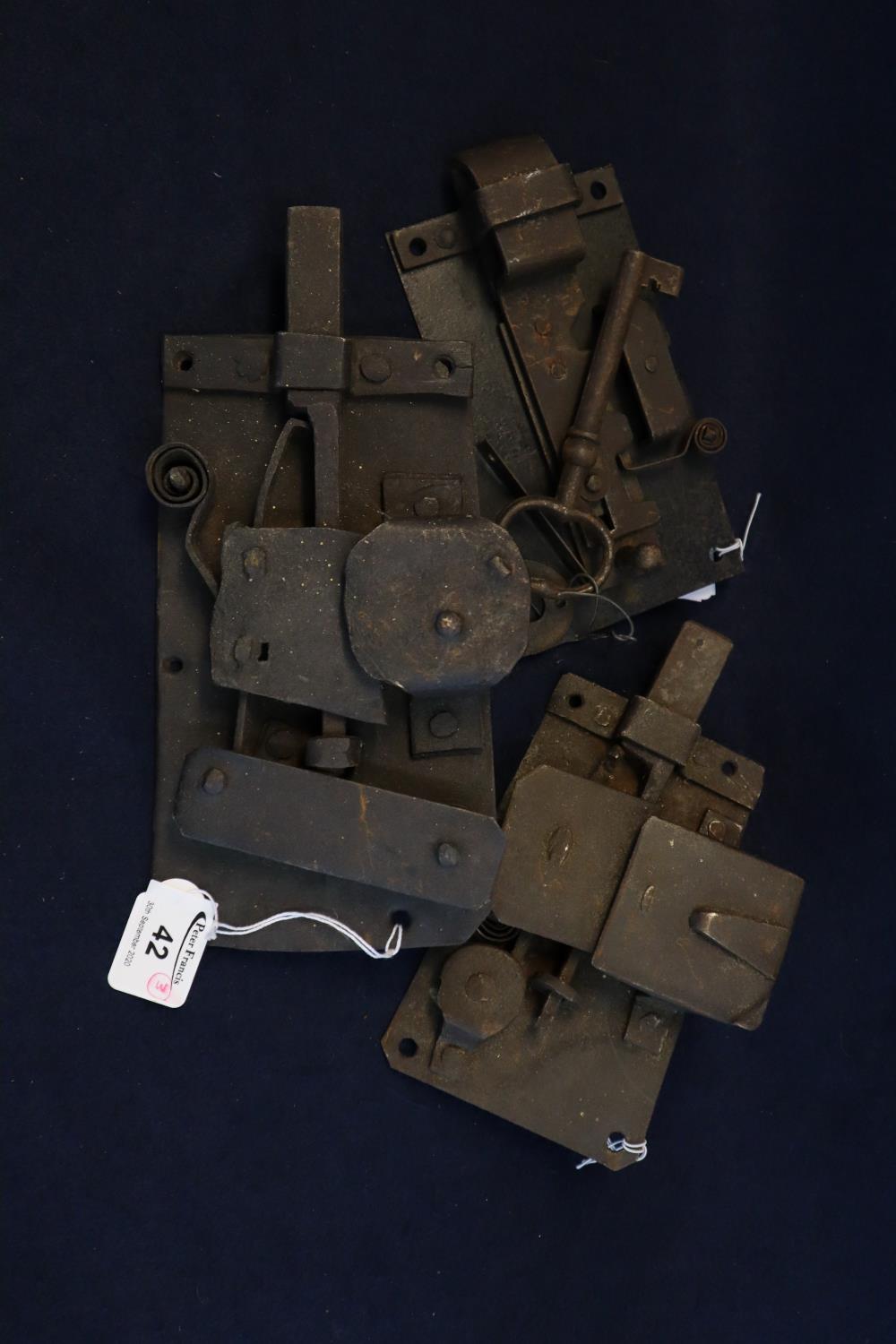 Three vintage iron and steel door locks, together with one key. (3) (B.P. 21% + VAT)
