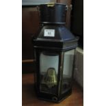 Flat backed wall lamp/lantern with swing handle and brass burner and reservoir. 43 cm high