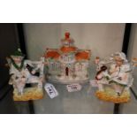 Staffordshire pottery study of a cottage together with a pair of German figurines seated on a
