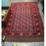 Middle eastern design carpet on a red ground with geometric stylized panels and decoration . Size