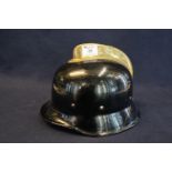 Mid 20th century German police/fireman's helmet. Black finish with brass comb and leather lining.