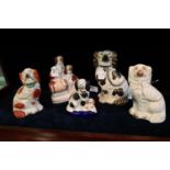 Collection of Staffordshire pottery fire-side spaniels including a spaniel group. Mainly 19th